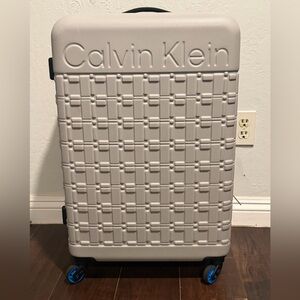 Calvin Klein Textured Gray Suitcase with Blue Accents